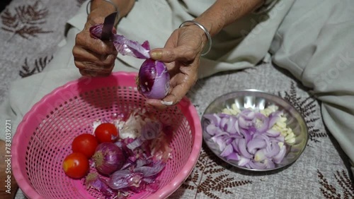 Old women cutting onions photo