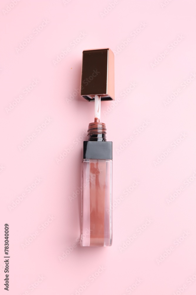 Bright lip gloss on pink background, top view Bright lip gloss on pink background, top view