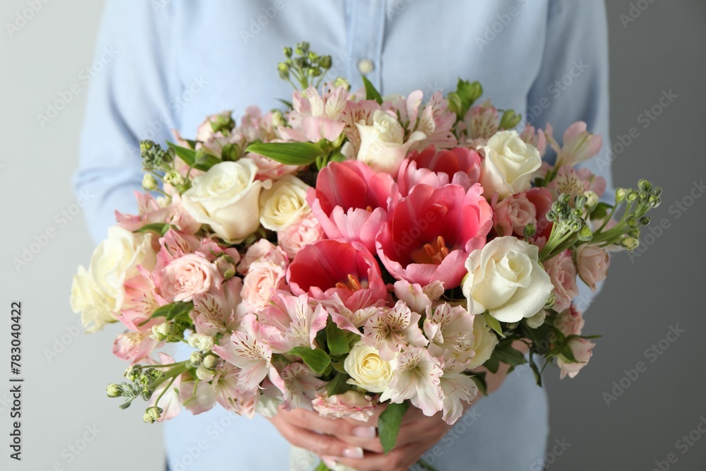 Woman with beautiful bouquet of fresh flowers on light background, closeup Woman with beautiful bouquet of fresh flowers on light background, closeup