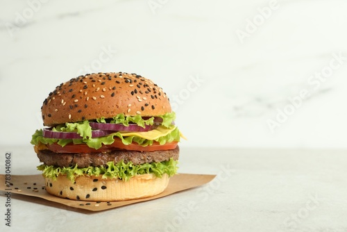Burger with delicious patty on light table, space for text