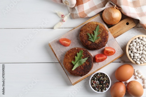 Wallpaper Mural Vegetarian product. Tasty bean cutlets served on white wooden table, flat lay. Space for text Torontodigital.ca