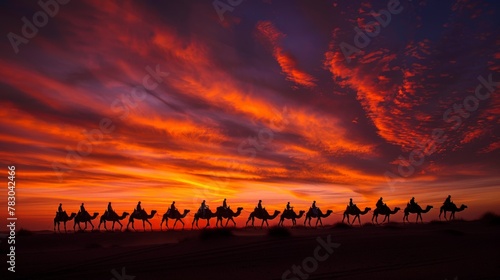 As the sun dips below the horizon, a caravan of camels and their cameleers traverse the desert sands, silhouetted against the fiery sky.