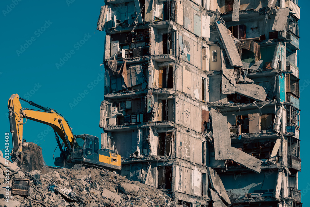 construction equipment destroys houses damaged during the war in Ukraine