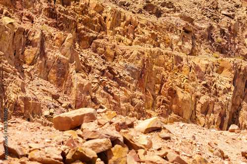 Dead Sea coastline of Jordan side. Cliffs consisting of multi-colored huge stones close-up. Nature concept for design.