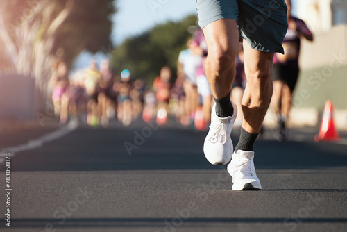 Marathon running in the light of morning. People feet on city road