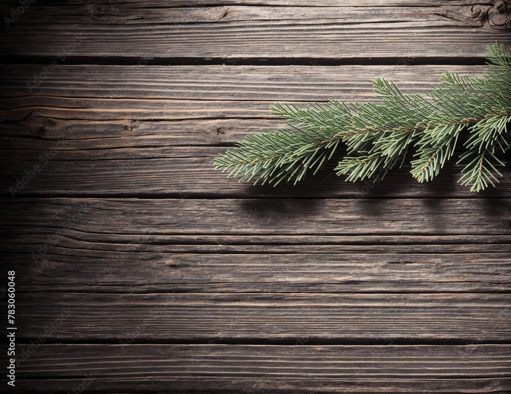 A wooden background with a pine branch hanging from it. A wooden background with a pine branch hanging from it.