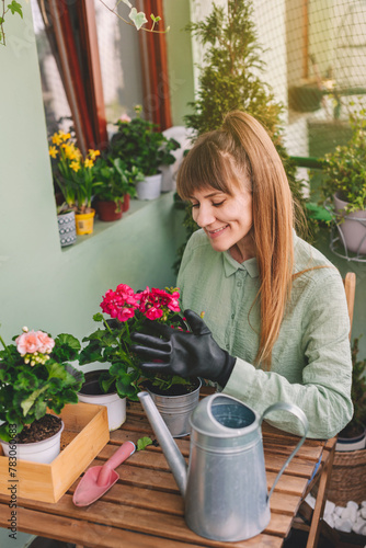 Gardener Woman Taking Care of Geranium Flowers (ID: 783060683)