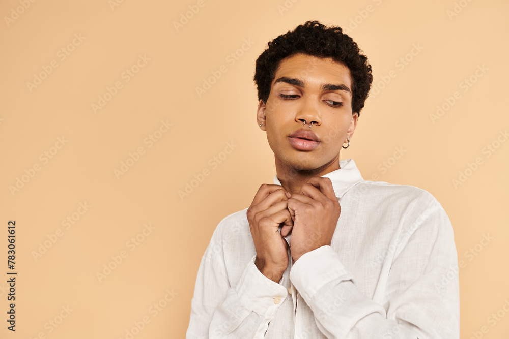 appealing chic african american man in elegant white clothing looking away on beige backdrop appealing chic african american man in elegant white clothing looking away on beige backdrop