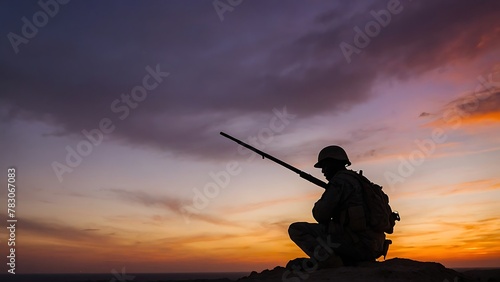 Silhouette of a soldier with a rifle on the sunset background