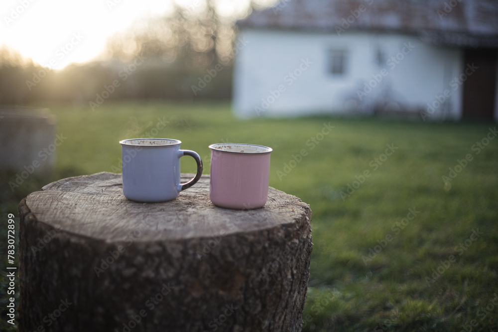a cup of coffee stands on a wooden table in the garden a cup of coffee stands on a wooden table in the garden