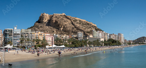 Postiguet beach in the city center of Alicante with the ruins of the historic Santa Barbara castle in the background, Alicante, Spain