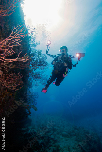 An underwater photographer exploring the WWII wreck of the Benwood off Key Largo in the Florida Keys