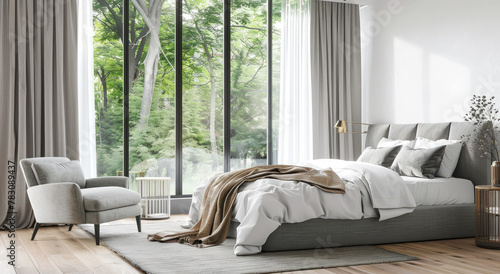 A bedroom with large windows and wooden floors, featuring gray bedding, a grey armchair, white curtains, and green plants outside the window © Kien