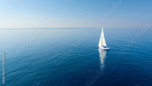 Wave and sail yacht on the sea as a background. Sea and waves from top view. Blue water background from top view. Top view from drone. Summertime vacation. Travel image
