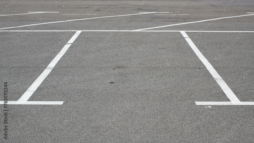 Parking lot markings, black and white stripes. Empty parking place at store
