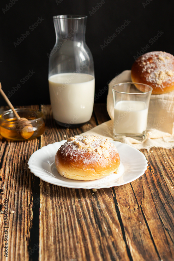 Fresh rolls with milk. on a dark wooden background. morning Fresh rolls with milk. on a dark wooden background. morning
