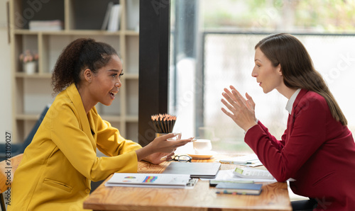 Bild auf Leinwand Diverse businesswomen engaging in a lively discussion during a professional meet