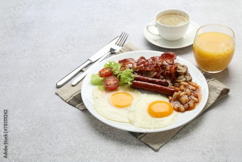 Delicious breakfast with sunny side up eggs on light table. Space for text