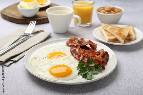 Delicious breakfast with sunny side up eggs served on light table