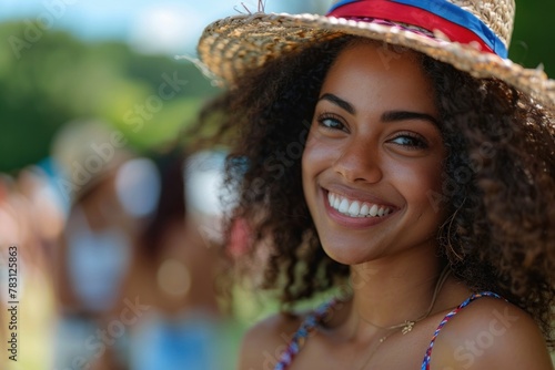 The joyous atmosphere of a 4th of July celebration is enhanced by the presence of a delightful African American woman with a beaming smile.  © Jam
