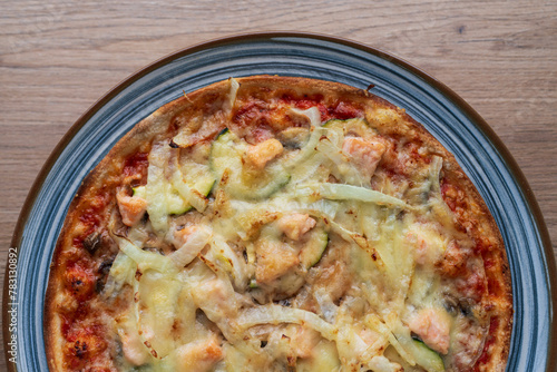 Italian homemade pizza with salmon and onions and parmesan, Italian cooking
