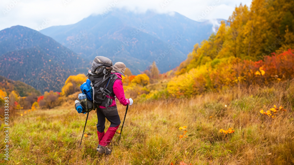 Person Hiking in the Autumn Mountains
