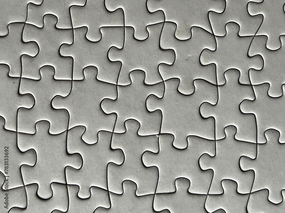 Gray interlocked jigsaw puzzle pieces with copy space Gray interlocked jigsaw puzzle pieces with copy space