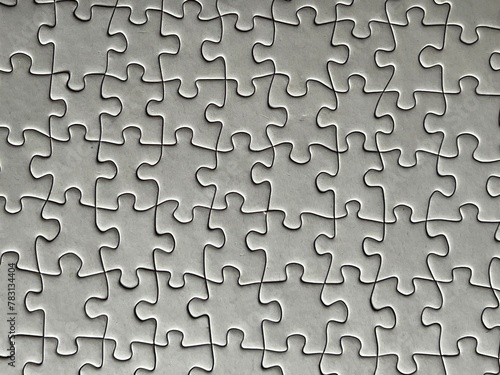 Gray interlocked jigsaw puzzle pieces with copy space
