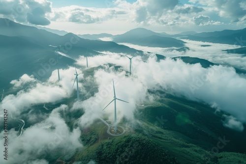 Wind turbines atop mountain, surrounded by clouds, in natural landscape