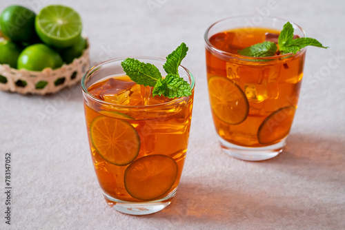 Iced tea with lime and mint leaf