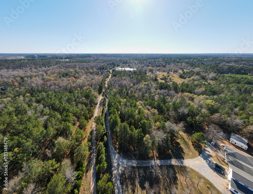 Aerial landscape of forest and a gravel trail in rural Appling Georgia