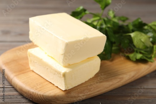 Tasty butter and parsley on wooden table, closeup