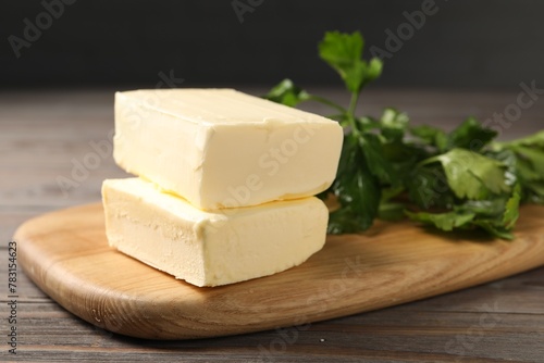 Tasty butter and parsley on wooden table, closeup