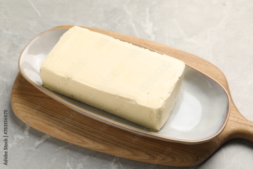 Block of tasty butter on grey table Block of tasty butter on grey table