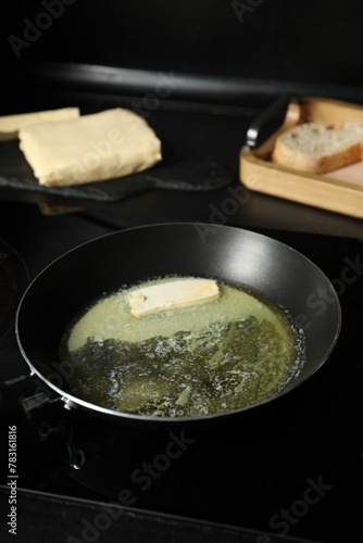Melting butter in frying pan on cooktop