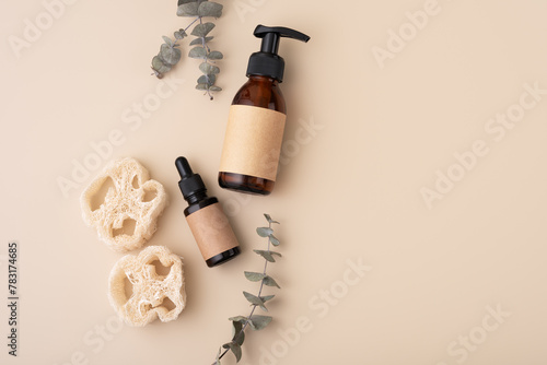 Eco-friendly skincare accessories concept with loofah sponges, cosmetic glass bottles and eucalyptus © viktoriya89