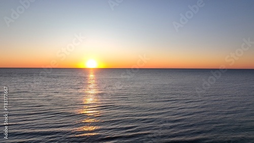 Beautiful morning sunrise over the ocean at the beach with warm sunlight shining on peaceful sea with calm gentle surf and waves at Pawleys Island  South Carolina low country lifestyle by the seashore