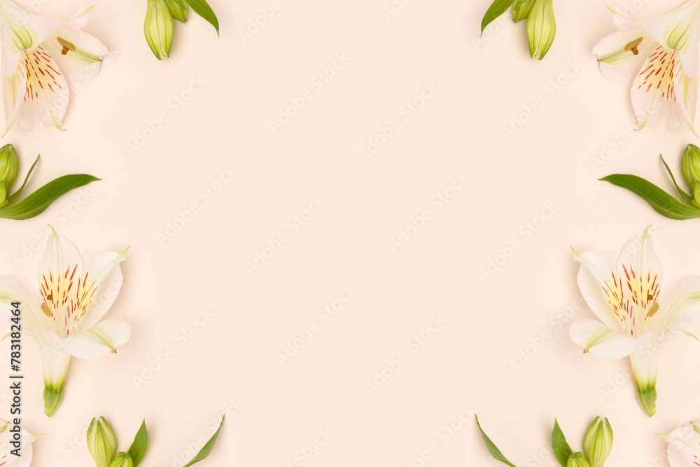 Frame made of alstroemeria flowers and green leaves on a beige background. Gentle springtime concept. Frame made of alstroemeria flowers and green leaves on a beige background. Gentle springtime concept.