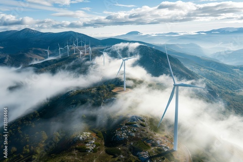 Wind turbines on mountain in clouds stunning aerial view