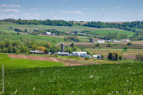Farms and fields on rolling hills in the Iowa countryside during spring