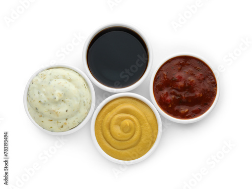 Many different sauces in bowls on white background, top view