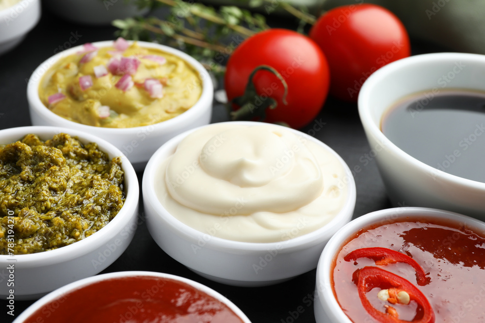 Different tasty sauces in bowls on table, closeup Different tasty sauces in bowls on table, closeup