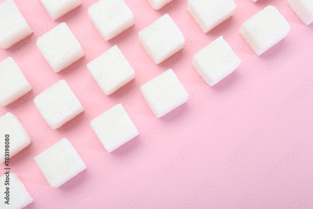 White sugar cubes on pink background, top view. Space for text White sugar cubes on pink background, top view. Space for text