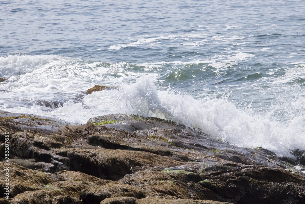 Ocean waves splashing on a rocky shore Ocean waves splashing on a rocky shore