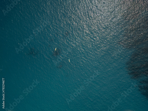 kayaks paddling in pacific ocean aerial shot Baja California Sur Mexico drone view