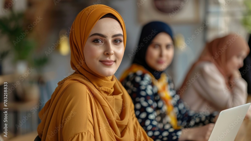 Women from diverse backgrounds wearing hijab collaborate on strategies for growth Women from diverse backgrounds wearing hijab collaborate on strategies for growth