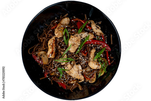 Asian wok noodles with chicken and vegetables with chopsticks on the table.