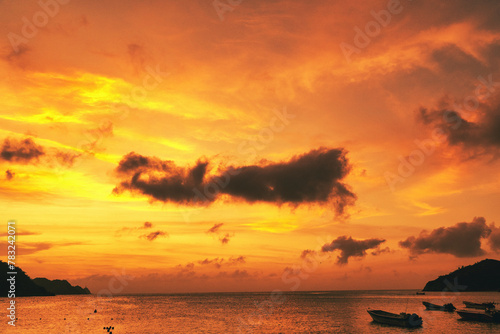 Landscape with beautiful sunset on the sea and boats on the shore. Taganga Beach. Santa Marta, Colombia. 