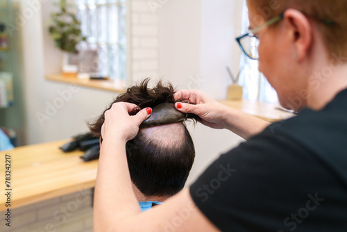 Photos Professional fitting a natural hair prosthesis.