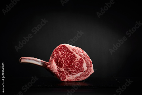 Wagyu beef on the bone on black slate photo